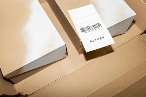 Online order return package with receipt document Stock Photos