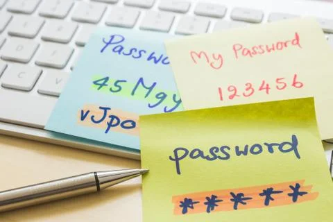 Online password management with keyborard, notes, pen. Stock Photos