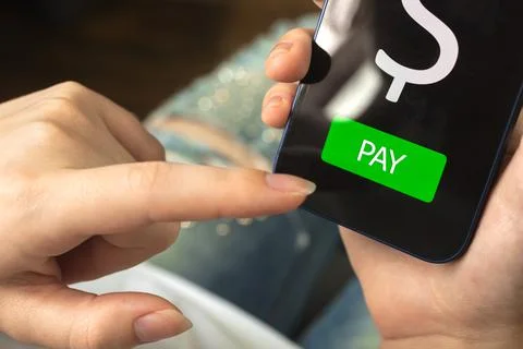 Online payment concept, pay button on the screen, woman suing smartphone and  Stock Photos