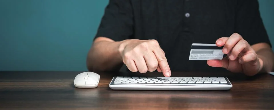 Online payment with e-commerce website. Young man paying and shopping with on Stock Photos