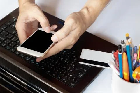 Online payment, man's hands  using smart phone for online shopping on the d.. Stock Photos