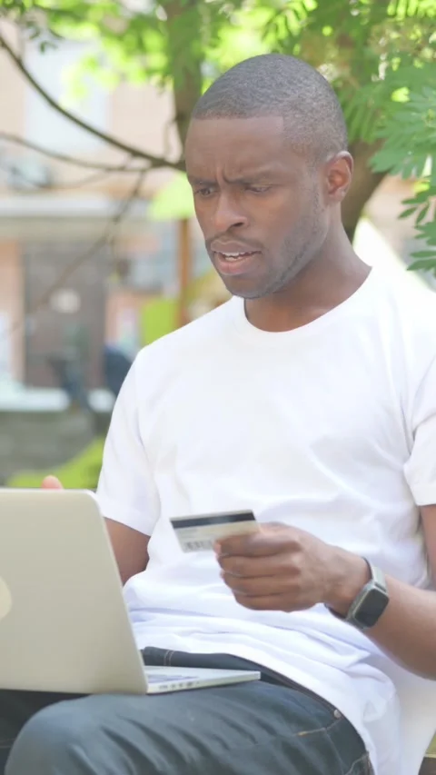 Online Payment Problems for African American Man Sitting in Park, Vertical Video Stock Footage 319028279