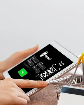 Online payment process using a tablet with a QR code displayed on the screen in Stock Photos