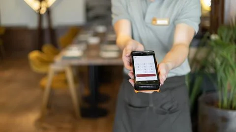 Online payment in restaurant using nfc technology. Customer making contactl.. Stock Photos
