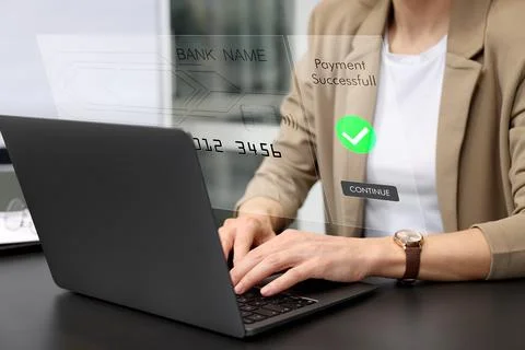 Online payment system interface over computer. Woman working on laptop at d.. Stock Photos