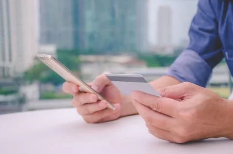 Online payment, young man using smart phone for online shopping Stock Photos