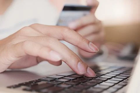 Online payment,Young Man's hands using credit card and computer laptop for Stock Photos