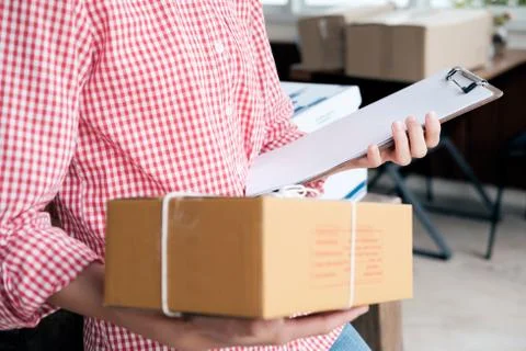 Online seller owner using computer for checking customer orders. Stock Photos