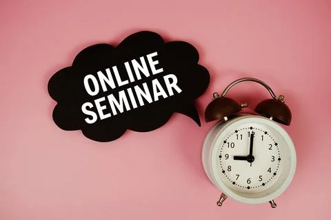 Online Seminar text on speech bubble with alarm clock on pink background Stock Photos