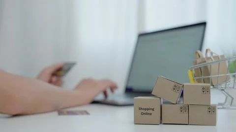Online shopping-boxes or parcels are placed on the table and shopping carts.  스톡 동영상 217962259
