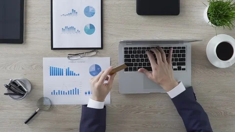 Online shopping, businessman inserting card number on laptop in office, finance Stock Footage
