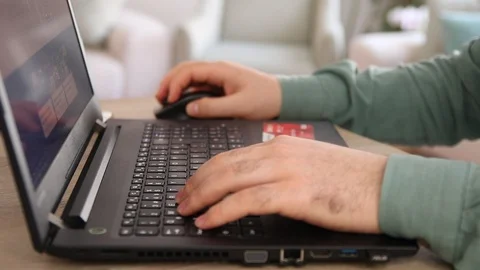 Online shopping on computer using a credit card Stock Footage 109659379