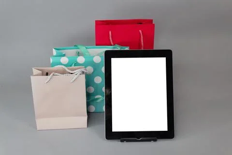 Online shopping concept. Close-up tablet mockup with white screen with bright Stock Photos
