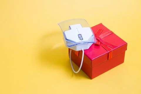 Online shopping concept, computer mouse made of transparent plastic on a red  Stock Photos