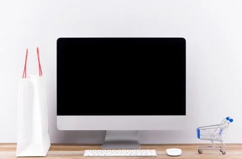 Online shopping concept with desktop computer screen isolated. Stock Photos