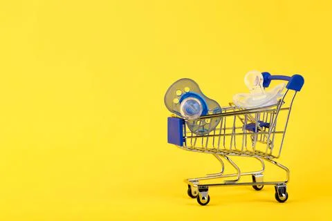 Online shopping concept. e-commerce, baby products, pacifier. yellow backgrou Stock Photos