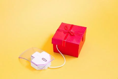 Online shopping concept, transparent plastic computer mouse and red bow-tie b Stock Photos