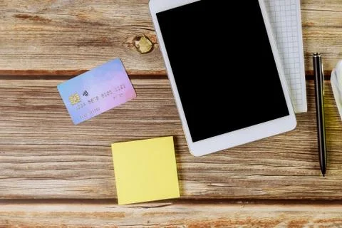 Online shopping using digital tablet and credit card blank notebook with pen Stock Photos