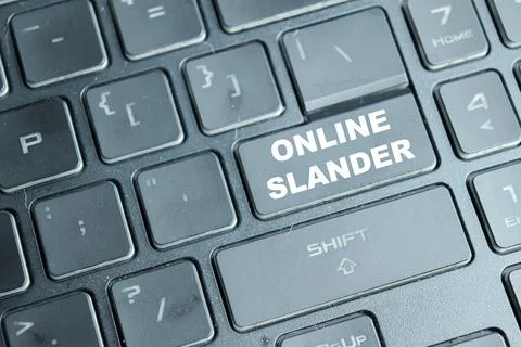 Online slander on the button keyboard. Online publication of a false Stock Photos
