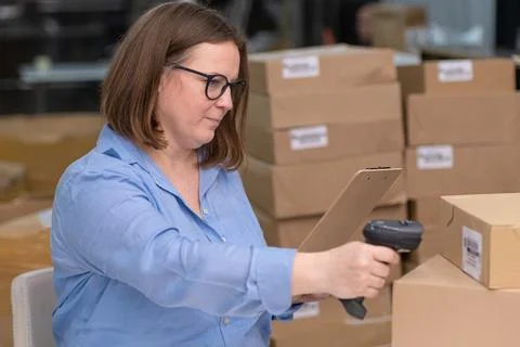 Online store workers scanning parcel boxes barcodes in their shop for tracking Stock Photos