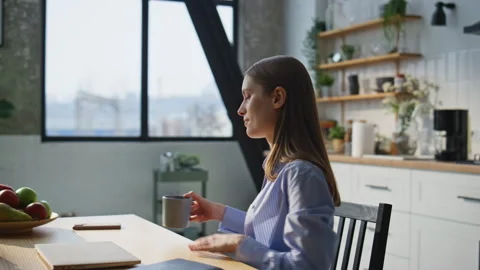 Online student opening laptop lid sit down apartment kitchen with coffee closeup Stock-Footage 283509684
