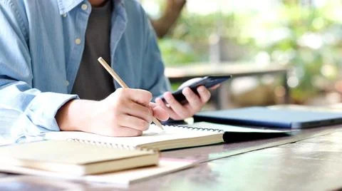 Online study, Man hand using mobile phone for digital home study class, Adult Stock Photos