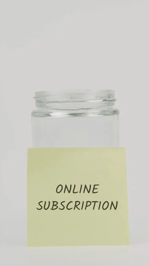 Online subscription text or word on yellow sticky note attached to glass jar 스톡 동영상 311761061