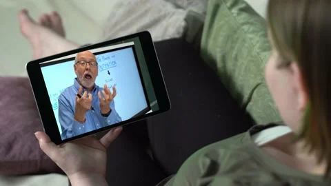 Online teacher communicating with teen g... | Stock Video
