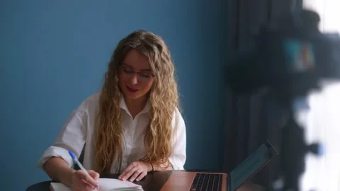 Online teacher live streaming lesson to students. Blogger filming content on Stock Footage 218468112