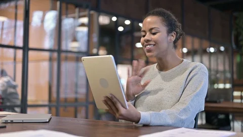 Online Video Chat on Digital Tablet by African Woman at Work Stock Footage 123838286