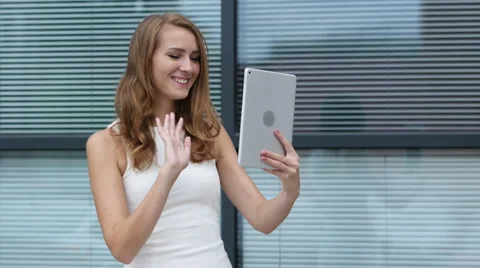 Online Video Chat on Tablet by Beautiful Girl, Outside Office Stock Footage 66793635