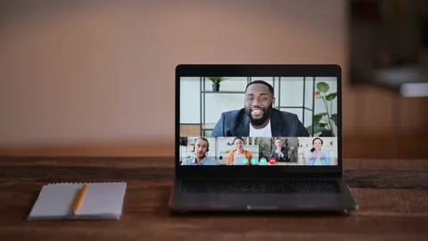 Online video communication. View at laptop screen with confident african Stock Footage 168476809