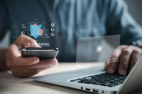 Online video e-learning on a laptop with courses charts and a phone data gr.. Fotos de archivo