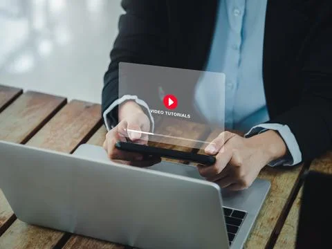 Online video tutorial concept. Red play icon on video tutorial virtual scre.. Stock Photos