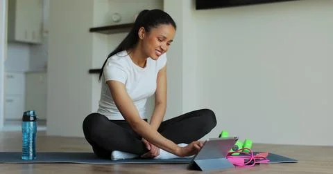 Online video tutorial while virtual training at home. Workout at home in livi Stock Photos