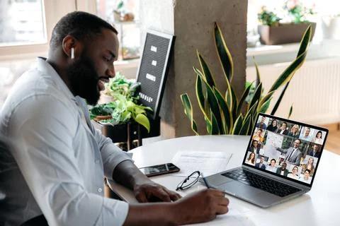 Online virtual meeting, e-learning. Focused african american man, student or Foto stock