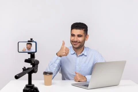 Online webinar, distant training. Elegant successful businessman sitting at w Stock Photos