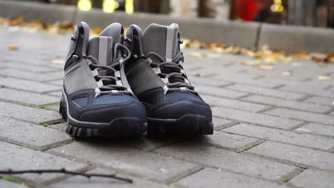 Only boots standing on sidewalk Stock Footage 141811838