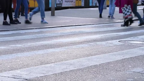 Only the bottom part of people of a crowd crossing a road Stock Footage 207772038