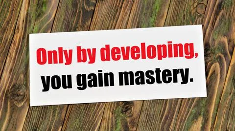 Only by developing, you gain mastery. Text inscription in the banner plate. Stock Photos