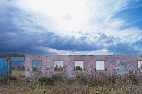 Only one wall remained from the old house. Wall of an old house in the open air Stock Photos