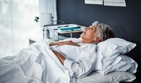 The only thing to do now is rest. High angle shot of a sickly senior woman lying Stock Photos