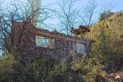 The only thing left of this old stone house is one wall and a two windows. Stock Photos