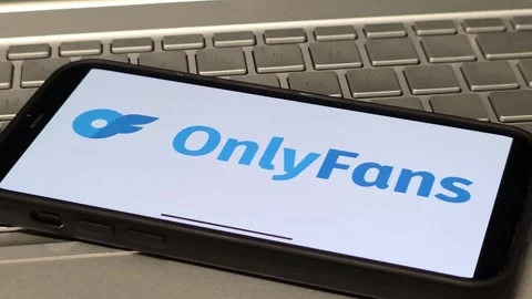 OnlyFans social platform logo displayed on mobile phone Video stock 324705818