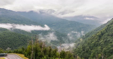 The onset of twilight in the mountains and the appearance of fog on a mountain Stock Footage 113640345