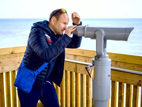 Ooking through binoculars Stock Photos
