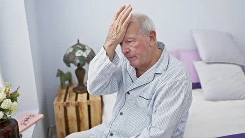Oops! confused senior man with white hair, sitting on bed in pyjamas, smack.. Stock Footage 270320679
