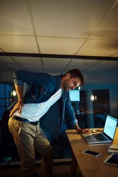 Oops, I forgot to stand up and stretch. a handsome young businessman standing up Stock Photos