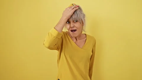 Oops! middle age woman with grey pony tail slapped her head over a forgotte.. Stock Footage 270320933