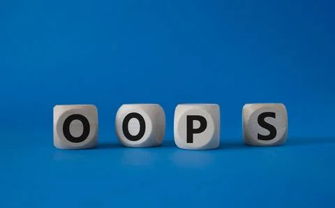 Oops symbol. Concept word Oops on wooden cubes. Beautiful blue background. .. Stock Photos